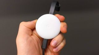 The Chromecast in a hand