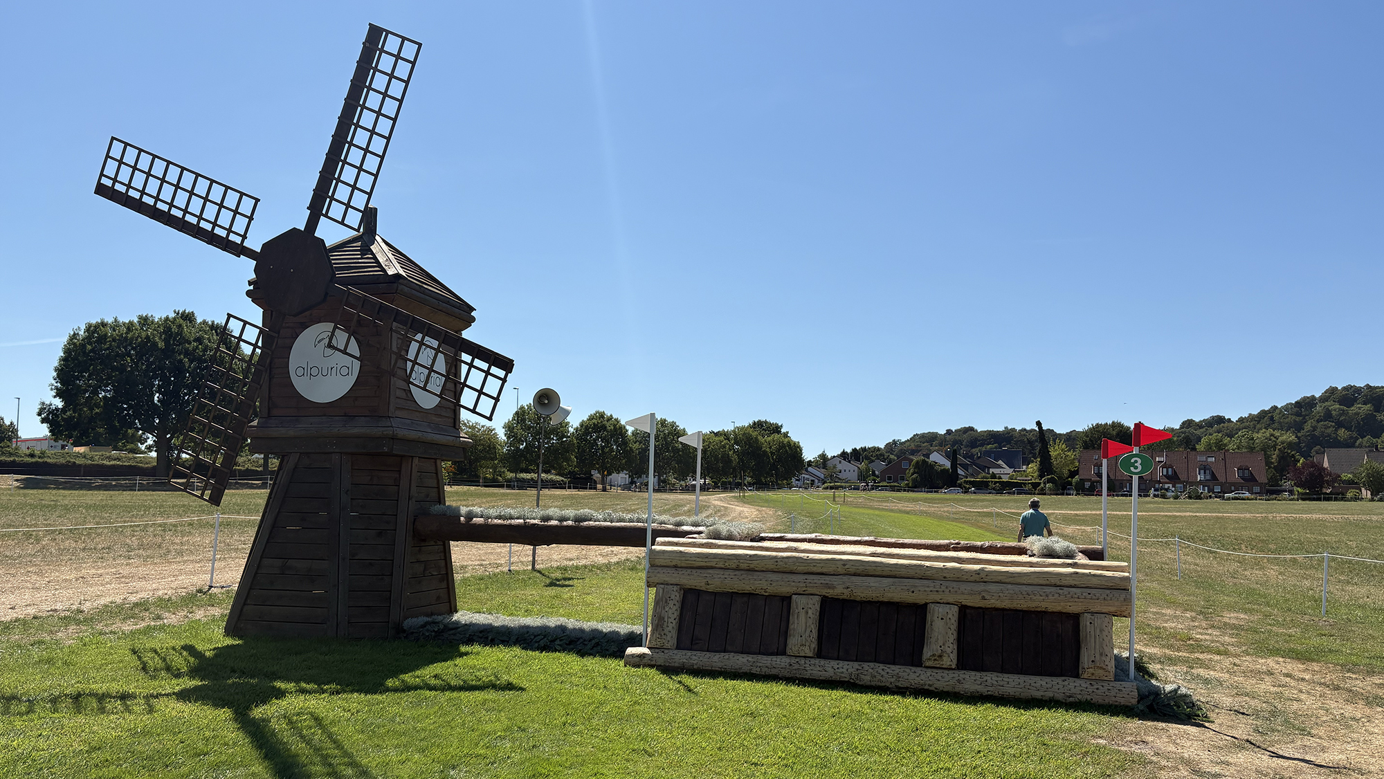 A table fence with a windmill beside it on the Aachen eventing World Championships cross-country course