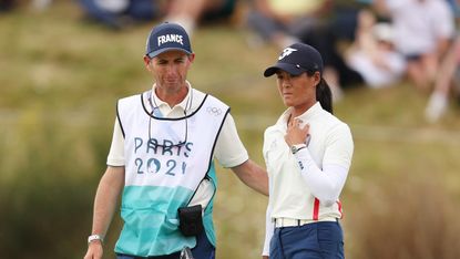 Colin Cann puts an arm around Celine Boutier at the Paris 2024 Olympic Games