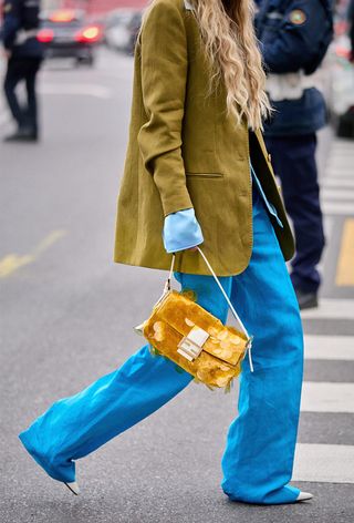 a photo of a woman wearing the italian bag brand Fendi