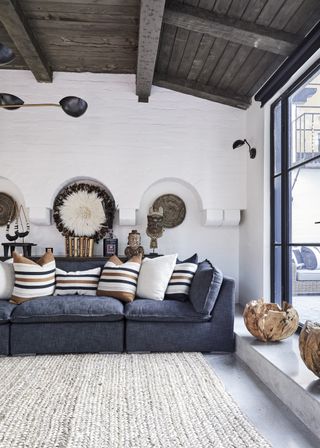 White living room with dark blue sofa