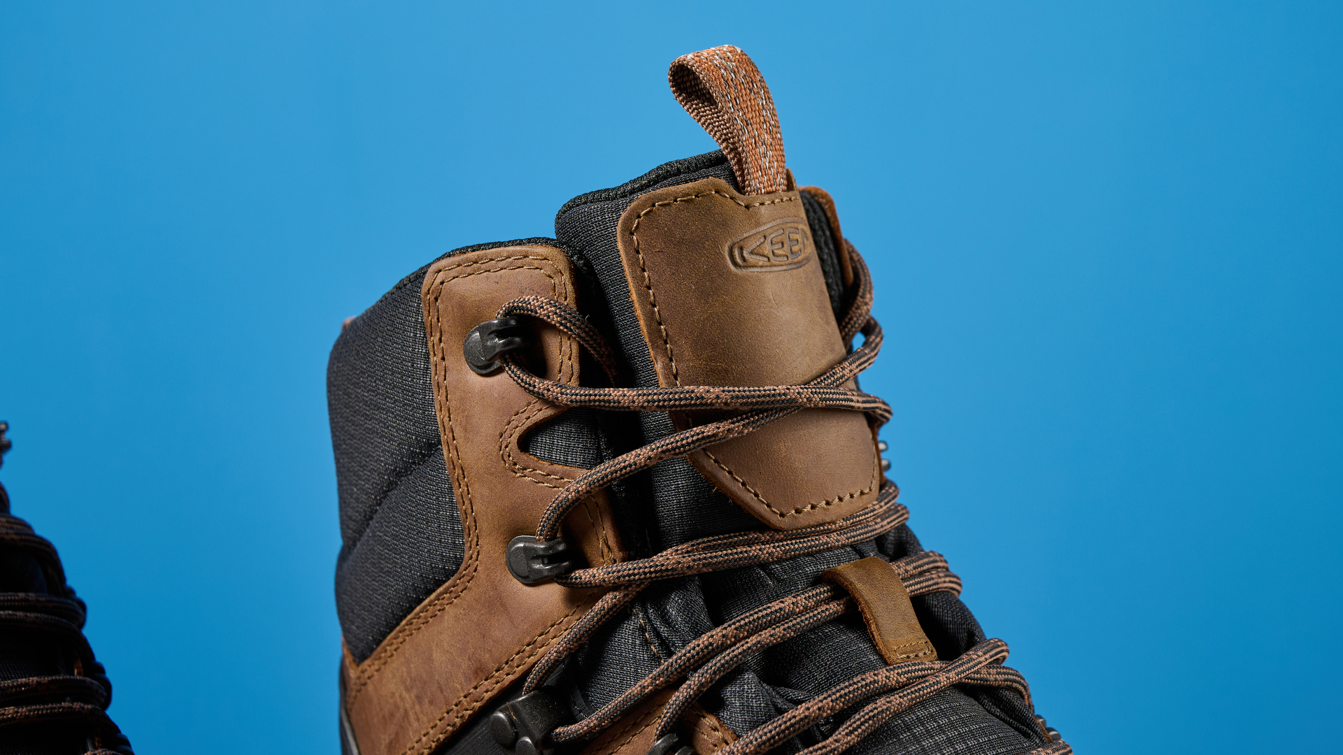 The Keen Revel IV tongue, in brown with a blue background