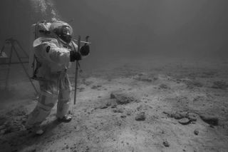 ESA astronaut instructor Hervé Stevenin ready to perform soil core sampling with a core tube and a hammer underwater off the coast of Marseille. During the mission, several soil samples were collected by the aquanauts with similar tools used on the Moon by the Apollo 11 crew. Image released Sept. 10, 2013.