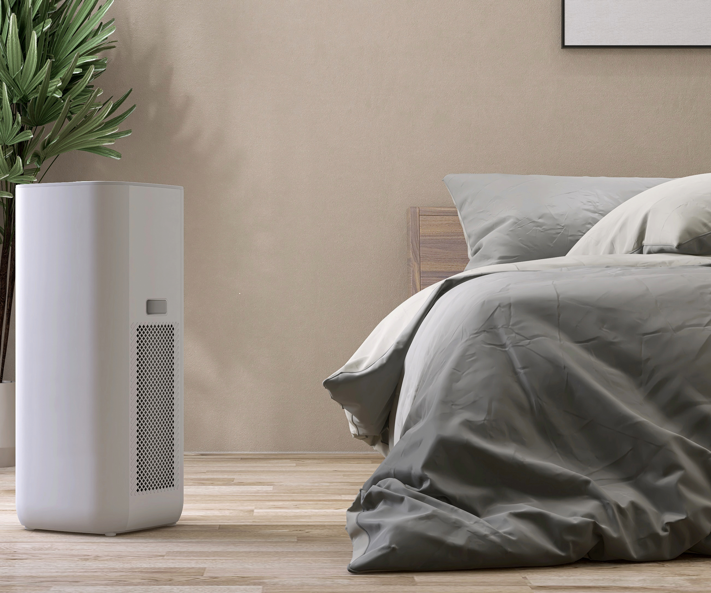Dehumidifier next to a bed with grey bedsheet on it and a plant in the corner of the room