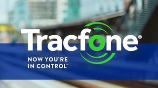 The Tracfone logo on a banner with text underneath that reads: "Now you're in control" set against a blurred cityscape background