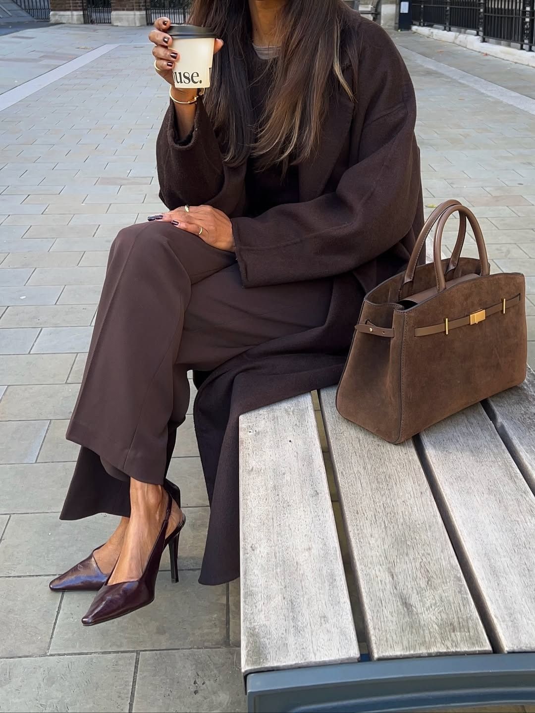 Woman in chocolate brown coat and pants.
