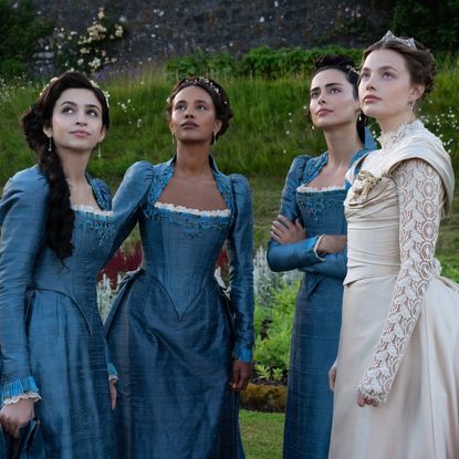 Josie Totah, Alisha Boe, Aubri Ibrag and Kristine Frøset wearing guilded age dresses in a garden in a still from the buccaneers season 2