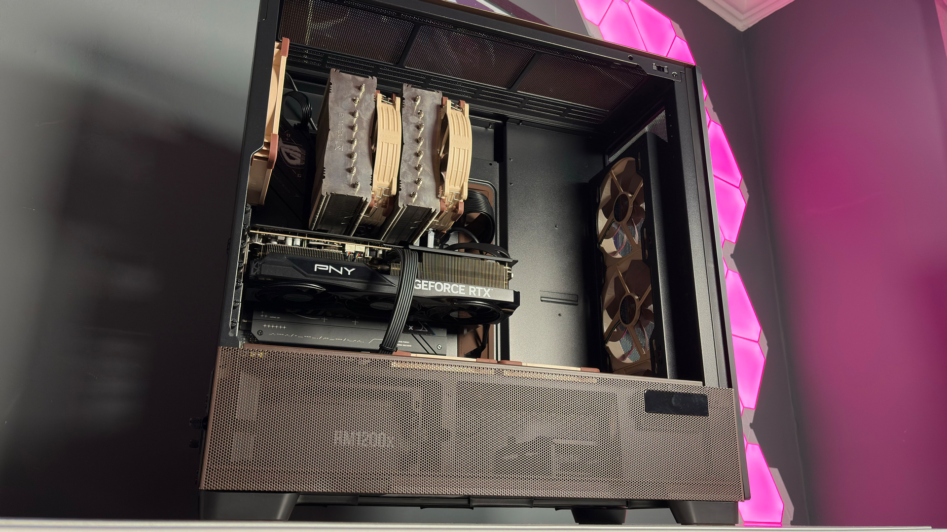 The Antec Flux Pro Noctua Edition on a desk with various parts disassembled.