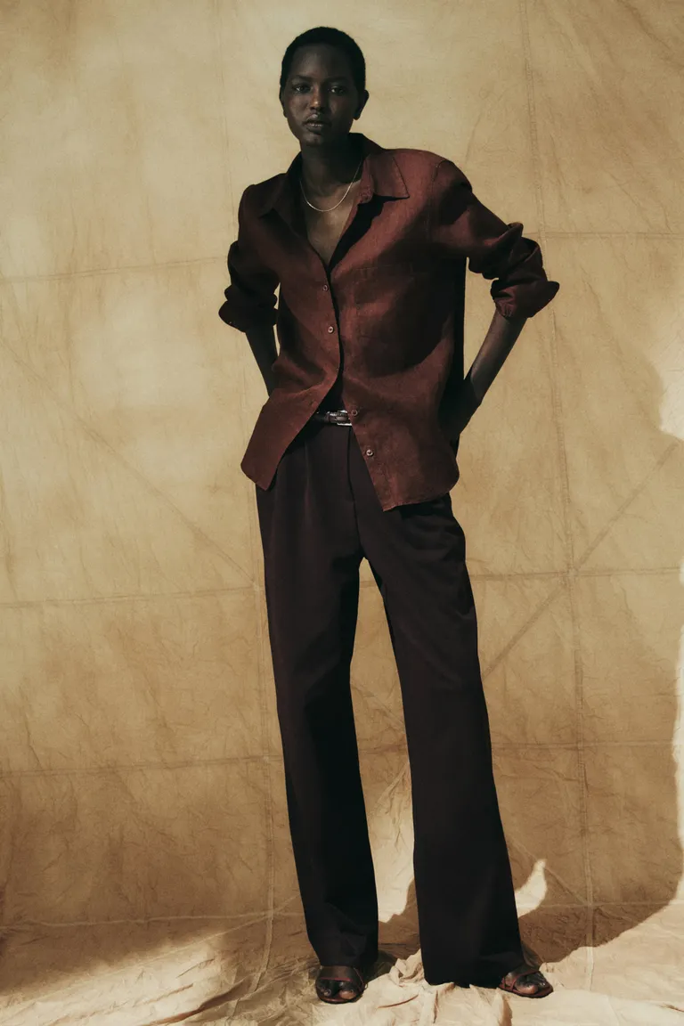 Model wears burgundy linen shirt