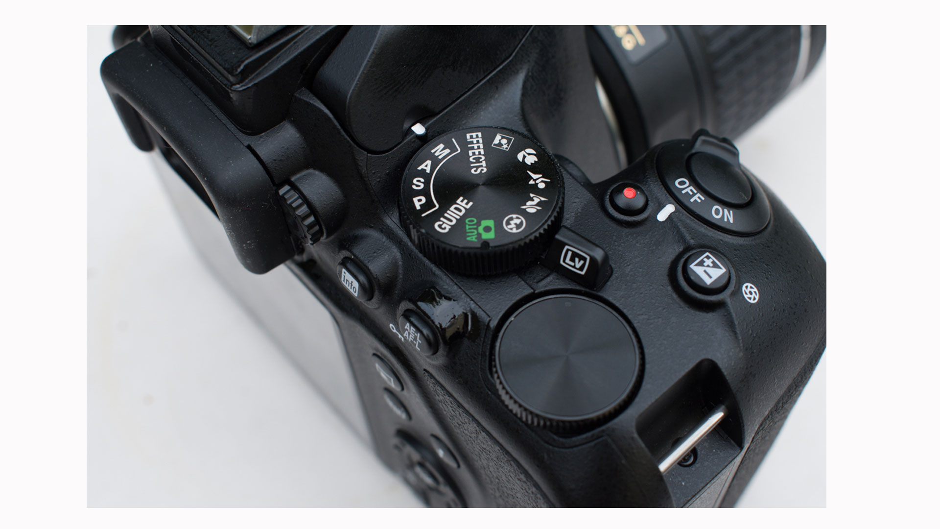 Image shows a closeup view of the controls and dials on the Nikon D3500.