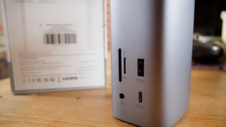 A silver Ugreen USB-C Triple Display Docking Station sitting on a desk