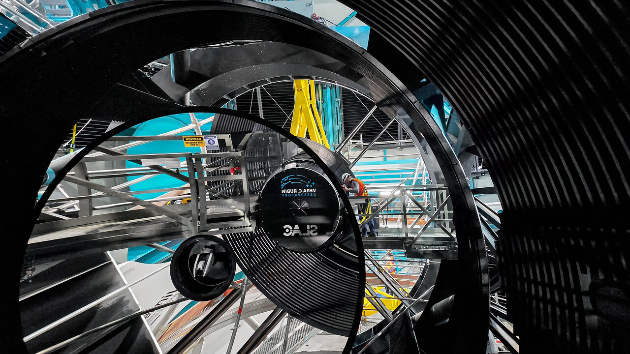 The Legacy Survey of Space and Time camera being installed by by a crew at the Vera C. Rubin Observatory