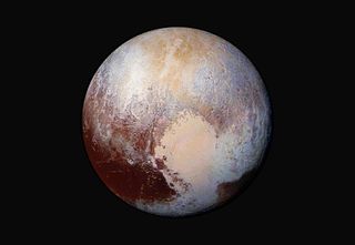 The "heart" on Pluto is and other surface details are clearly visible in this stunning false-color view of the dwarf planet captured by NASA's New Horizons spacecraft this month. NASA unveiled the image on July 24.