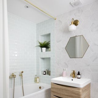 Bathroom with mirror on wall and bathtub