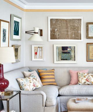 corner couch with patterned throw pillow and a galley wall