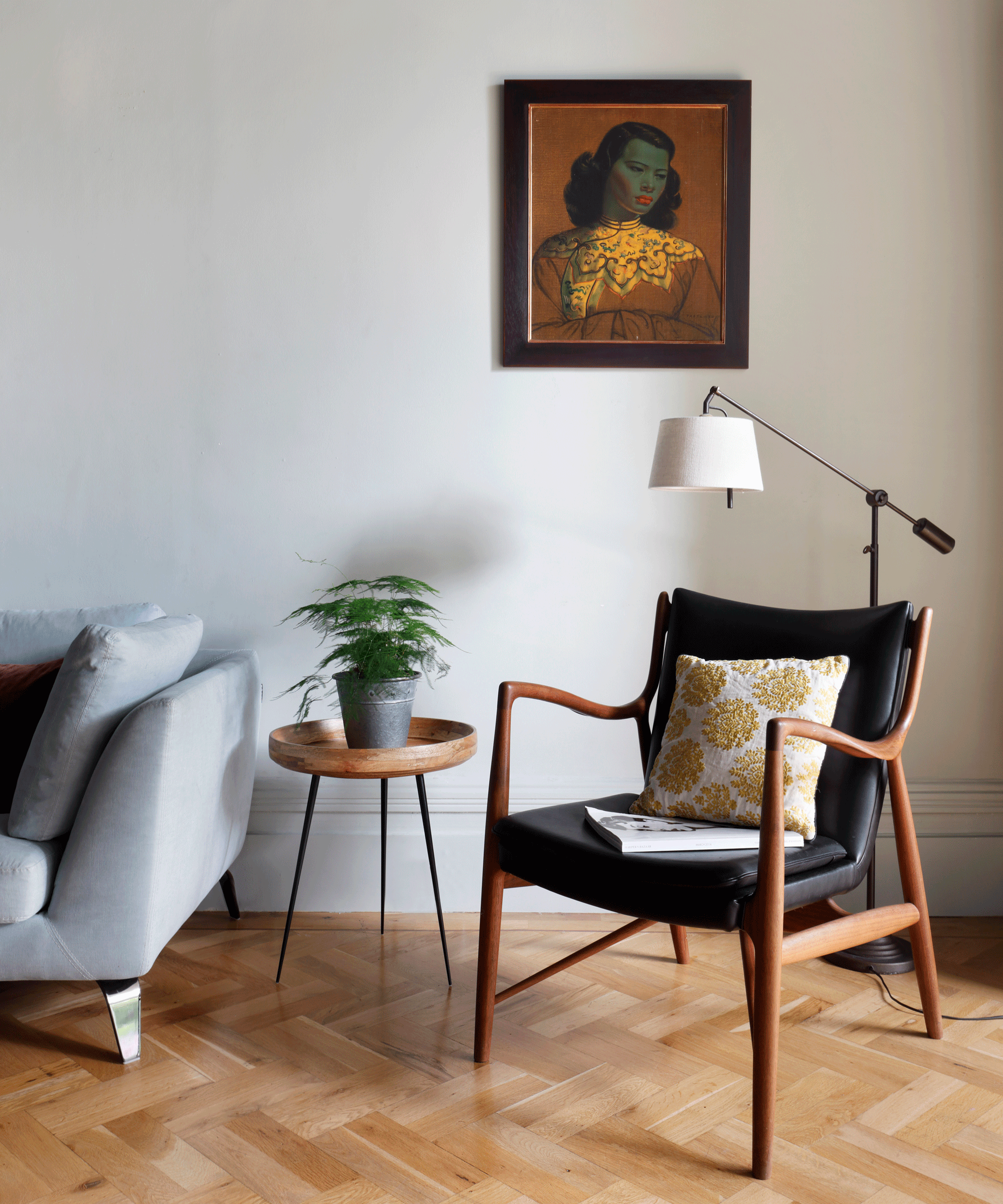 elegant mid-century modern armchair with floor lamp, side table and sofa
