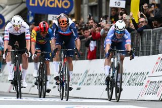 Alpecin-Deceuninck's Belgian rider Jasper Philipsen (R) cycles to cross the finish line during the 115th Milan-SanRemo one-day classic cycling race, between Pavia and SanRemo, on March 16, 2024. (Photo by Marco BERTORELLO / AFP)