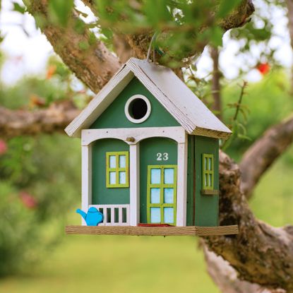cute birdhouse hanging in a tree