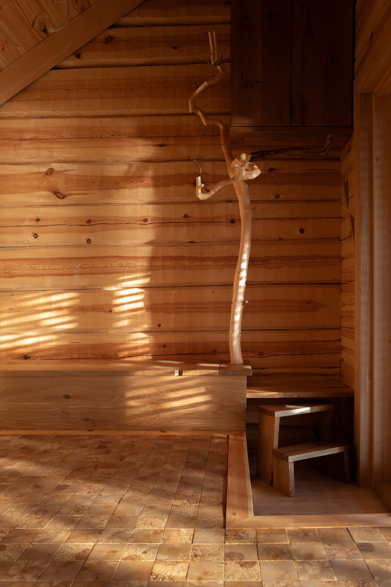 Puusauna, a log cabin timber sauna by Jaakko Torvinen set in the woods of Finland