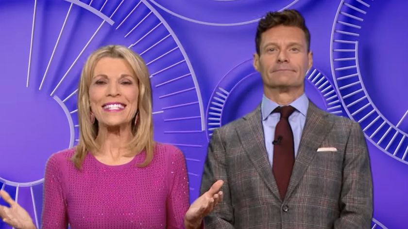 Vanna White and Ryan Seacrest talking to camera in Wheel of Fortune promo