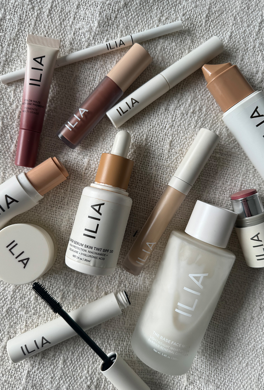 Flat lay picture of Ilia makeup samples on textured background