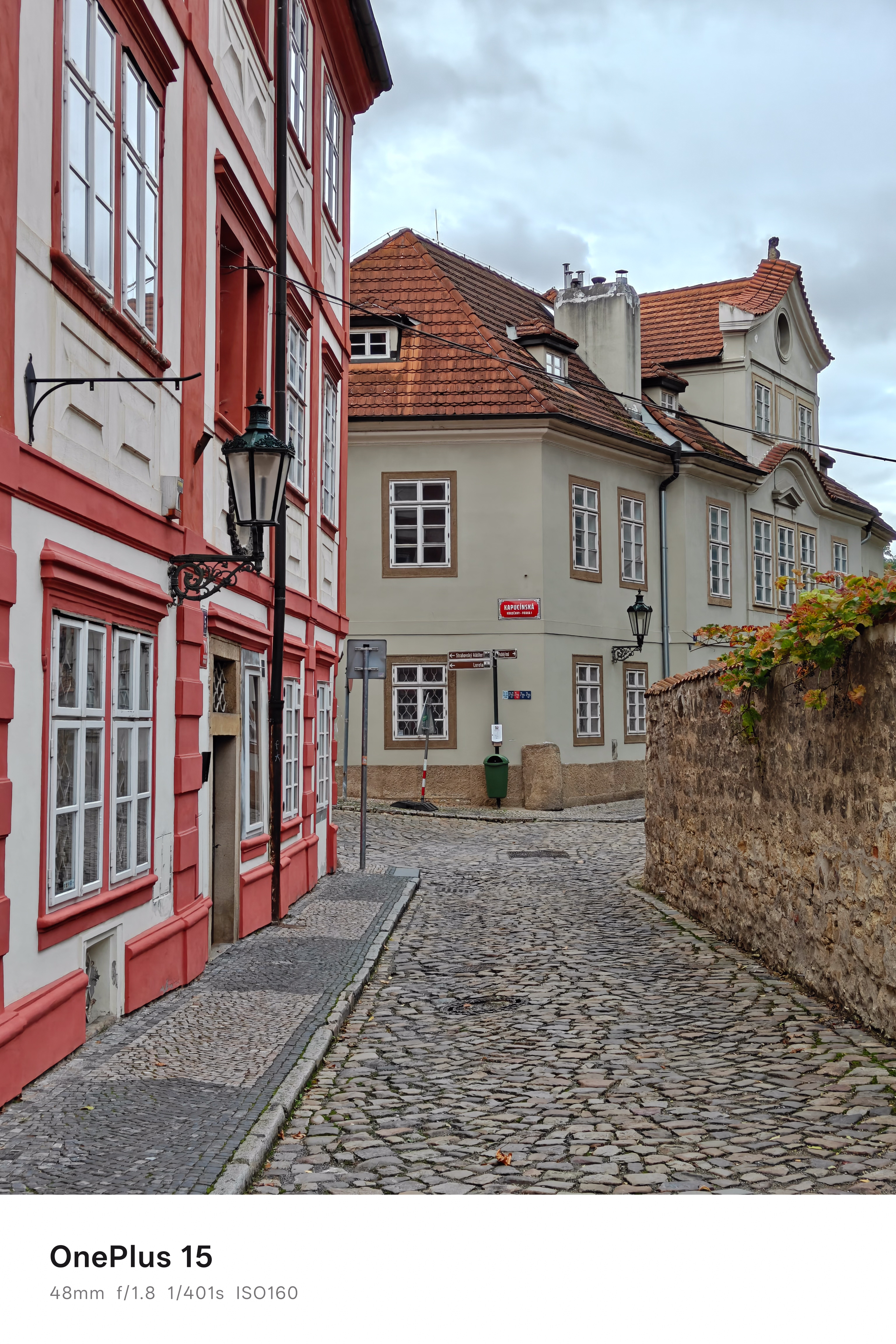 A historic cobbled street in Prague with colourful buildings