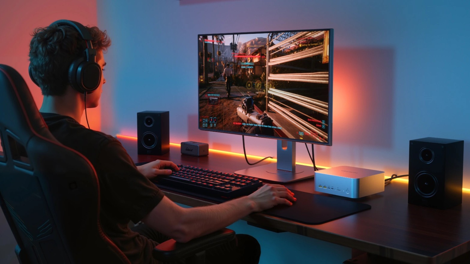 A lifestyle shot of the Geekom A9 Mega on a desk playing a video game. 