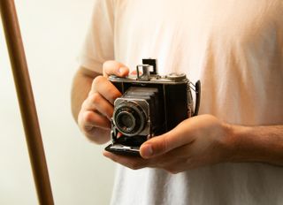 man holds vintage camera