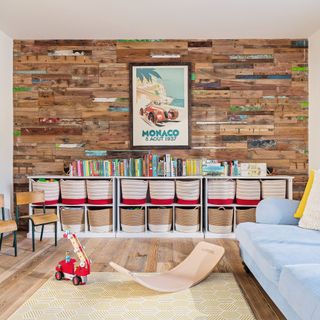 Reclaimed wood wall in playroom with toy storage boxes