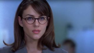Elizabeth Hurley stands smiling in a lab in Austin Powers: International Man of Mystery.