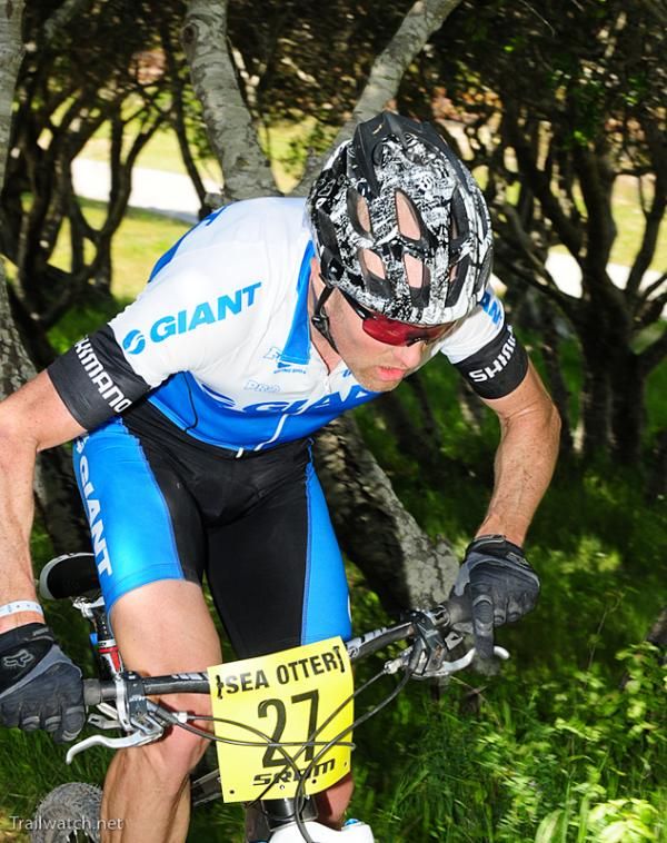 Carl Decker (Giant) climbs through some trees.