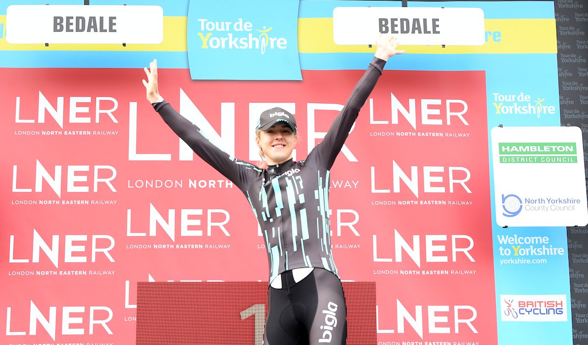 Leah Dixon of Team Brother UK Tifosi P/B On Form on the podium in the grey digital jersey for most active rider of the day.