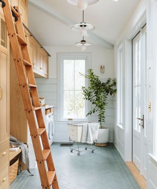 white utility room with wooden units and ladder, pale blue flooring