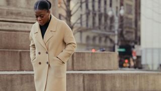 Street fashion, Clothing, Coat, Trench coat, Overcoat, Fashion, Outerwear, Suit, Standing, Headgear,
