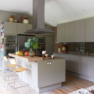 Grey kitchen with island and extractor hood