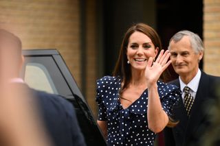 Kate Middleton waving as she gets into a car