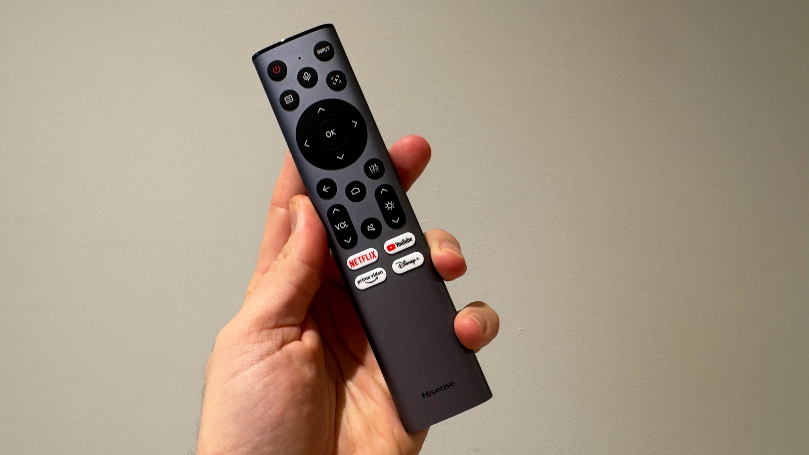The remote control for the Hisense C2 Ultra being held in a hand.
