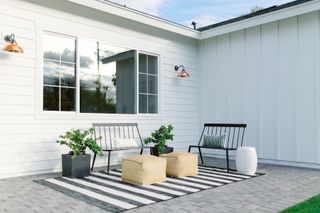 Front porch with benches, planters and outdoor rug