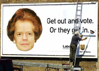 LONDON, UNITED KINGDOM:A man puts up a billboard showing the face of Conservative leader William Hague and former Prime minister Margaret Tatchers hair in the West London suburb of Ealing, 30