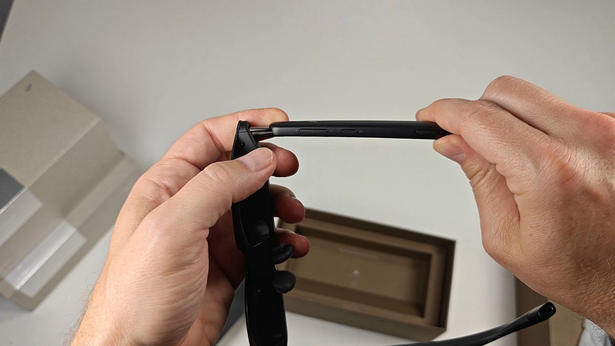 The buttons on the underside of the RayNeo GT smart glasses' left arm