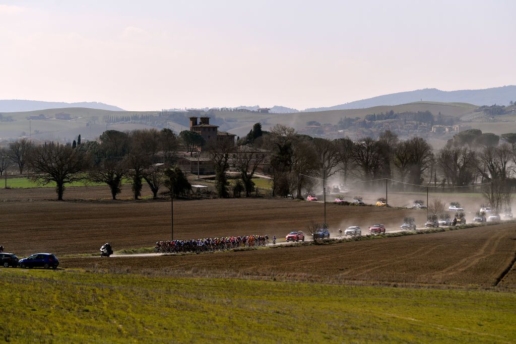 SIENA ITALY MARCH 05 A general view of the peloton passing through gravel roads landscape during the Eroica 8th Strade Bianche 2022 Womens Elite a 136km one day race from Siena to Siena Piazza del Campo 321m StradeBianche on March 05 2022 in Siena Italy Photo by Luc ClaessenGetty Images