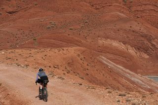 Image shows Anna cycling in the Atlas mountains in Morocco