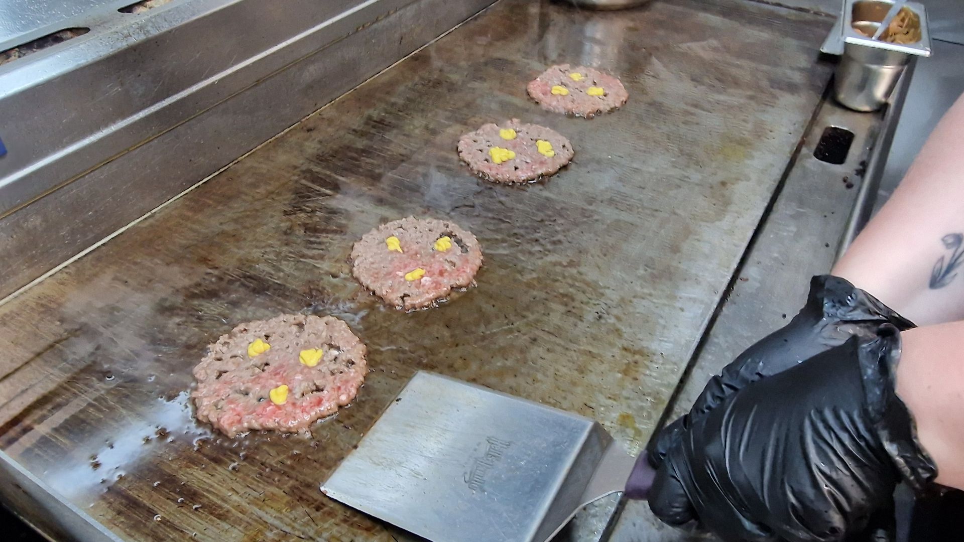 Smash burger starting to cook on a flat grill