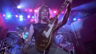 Christopher Guest as Nigel Tufnel shredding his guitar with his tongue out in This Is Spinal Tap