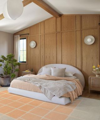 peach bedroom with wood panelled wall