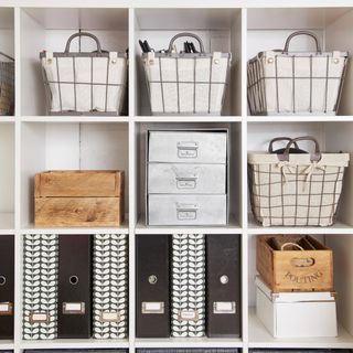 White shelving unit with various boxes, folders, and baskets displayed
