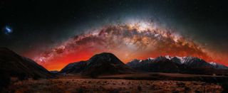 This image was taken in Castle Hill, New Zealand, facing south as the Milky Way set. Partway through the night, Hall-Fernandez noticed a faint glow growing stronger, though he was not expecting to see the Aurora Australis. As the aurora was very far away, only the deep reds were visible