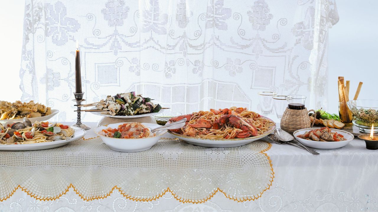 Table of dishes of food with candles