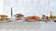 Table of dishes of food with candles