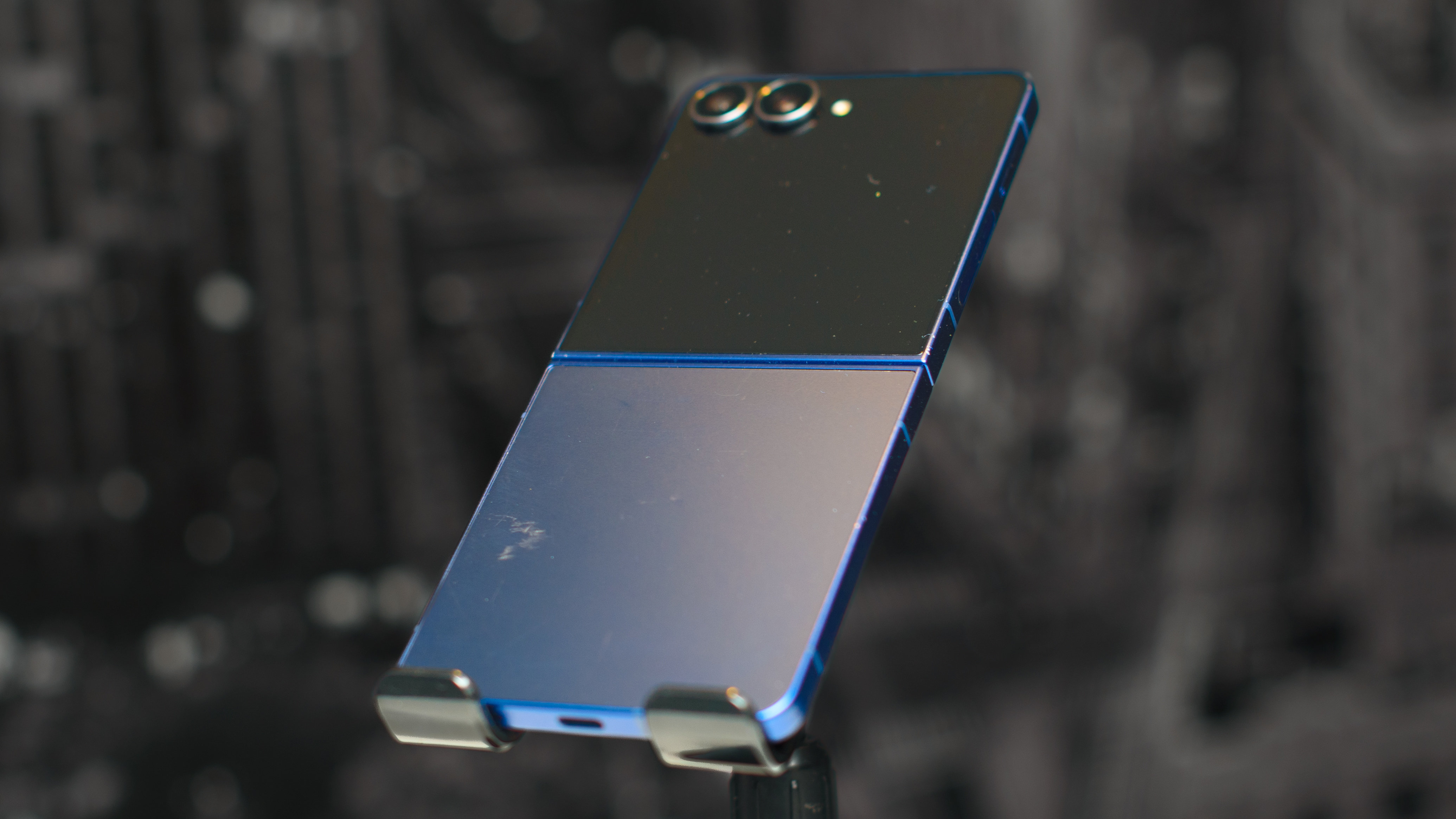 Samsung Galaxy Z Flip 7 in blue open at a 3/4 angle showing the back